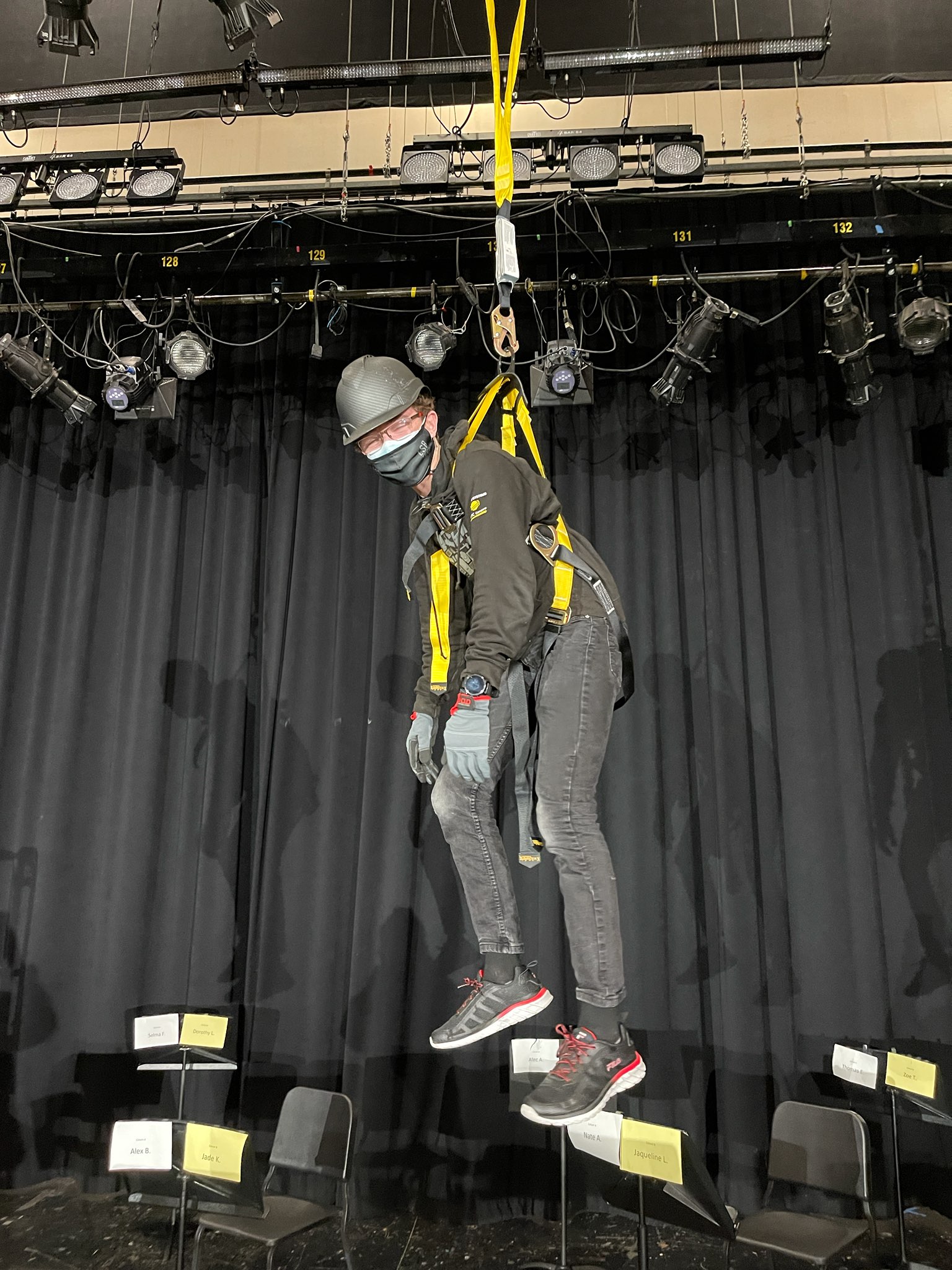 A drawing of Davin hanging via a harness.